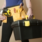Female worker wearing a toolbelt work apron for tools